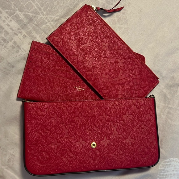The Félicie Pochette RED is crafted from Monogram Empreinte leather. - Picture 1 of 4